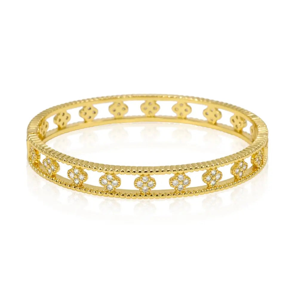 Gold bangle bracelet with floral designs.